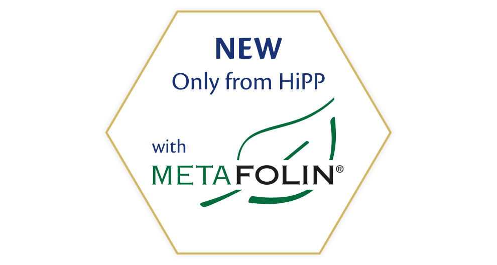 A white hexagonal shape with the text "NEW Only from HiPP with METAFOLIN®" in blue and green fonts.