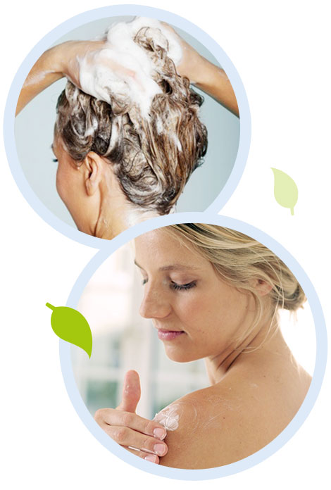 Two women, one washing her hair and the other applying lotion.
